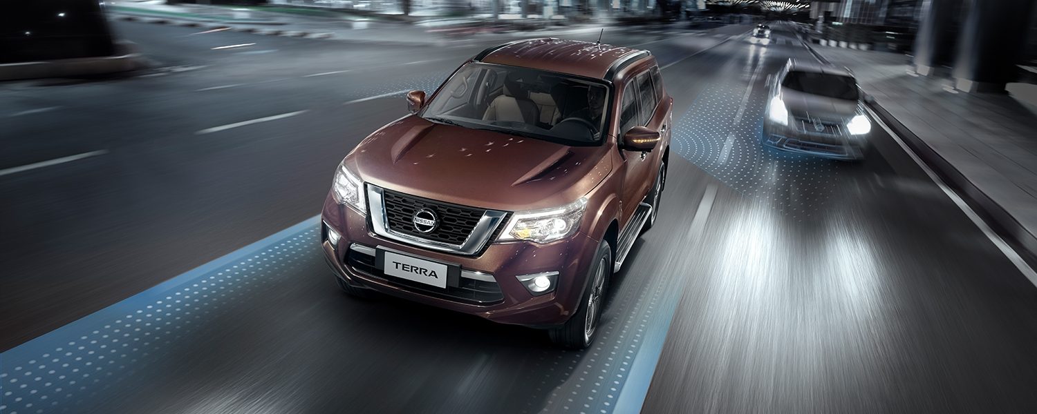 Nissan Terra driving on a city street at night