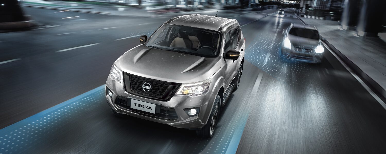 Nissan Terra driving on a city street at night