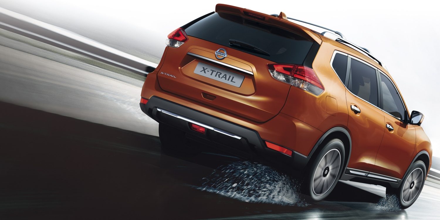 X-Trail driving rear shot on wet road