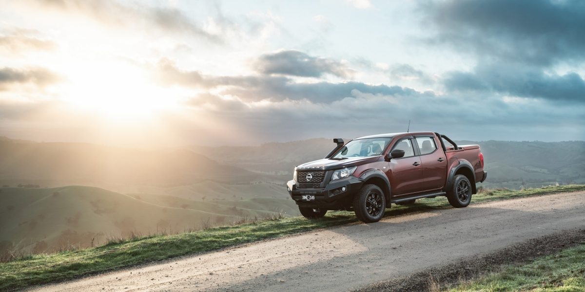 A Nissan car in front of a landscape