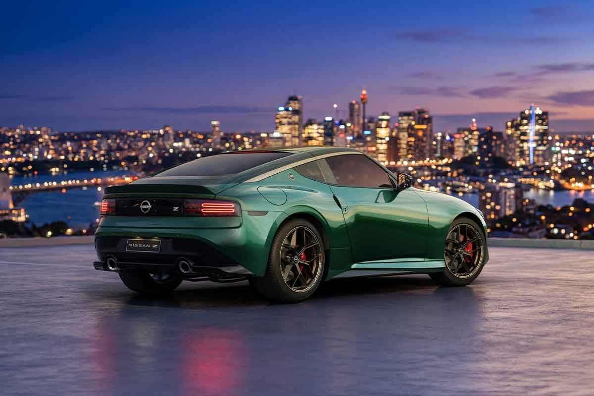 Nissan Z Coupe rear three-quarter angle parked overlooking a city skyline at dusk