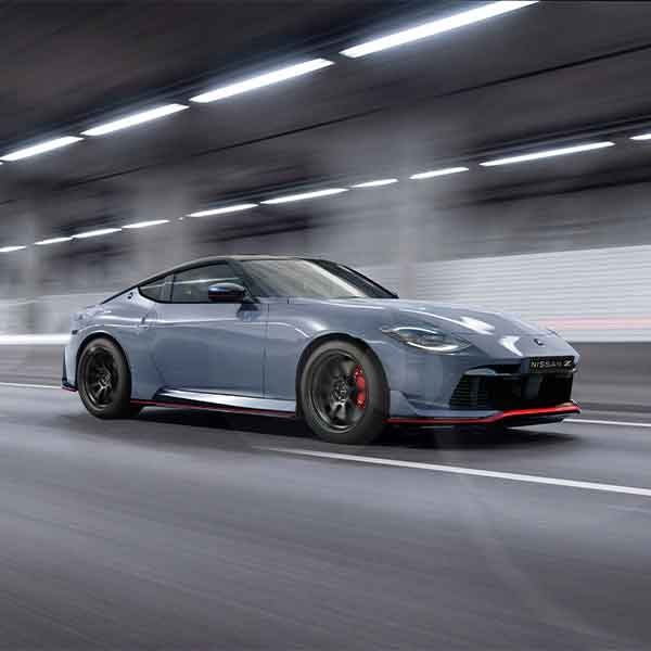Nissan Z Nismo driving through a tunnel with motion-blurred light trails