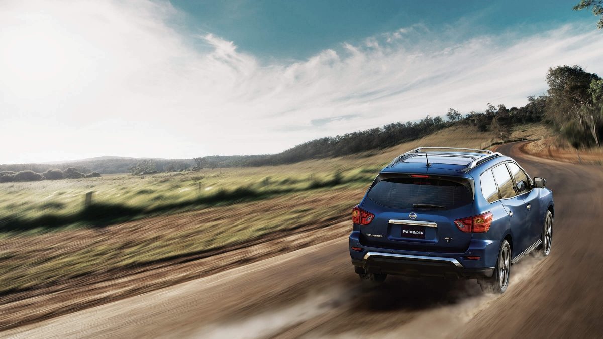 Nissan Pathfinder driving down offroad trail