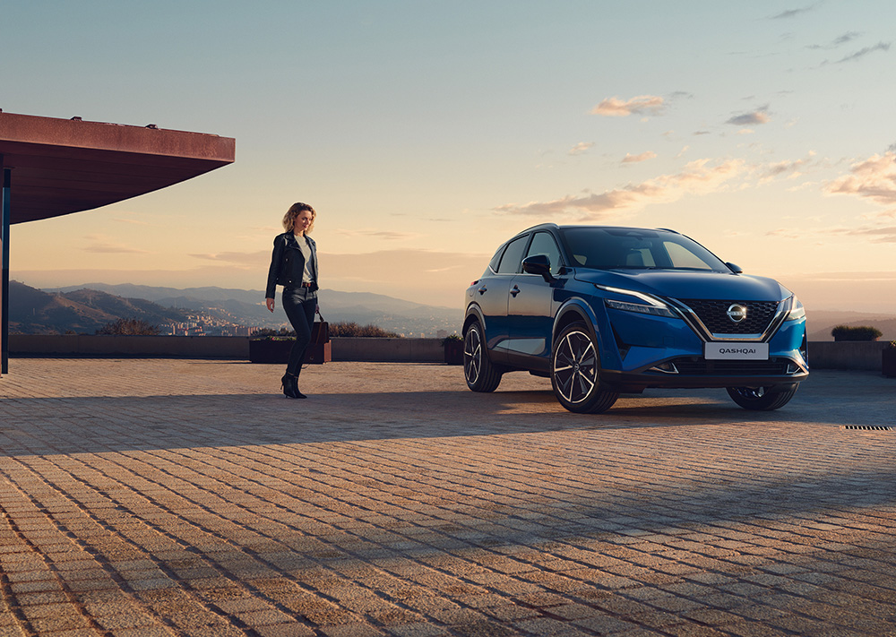 A woman walking to a Nissan QASHQAI