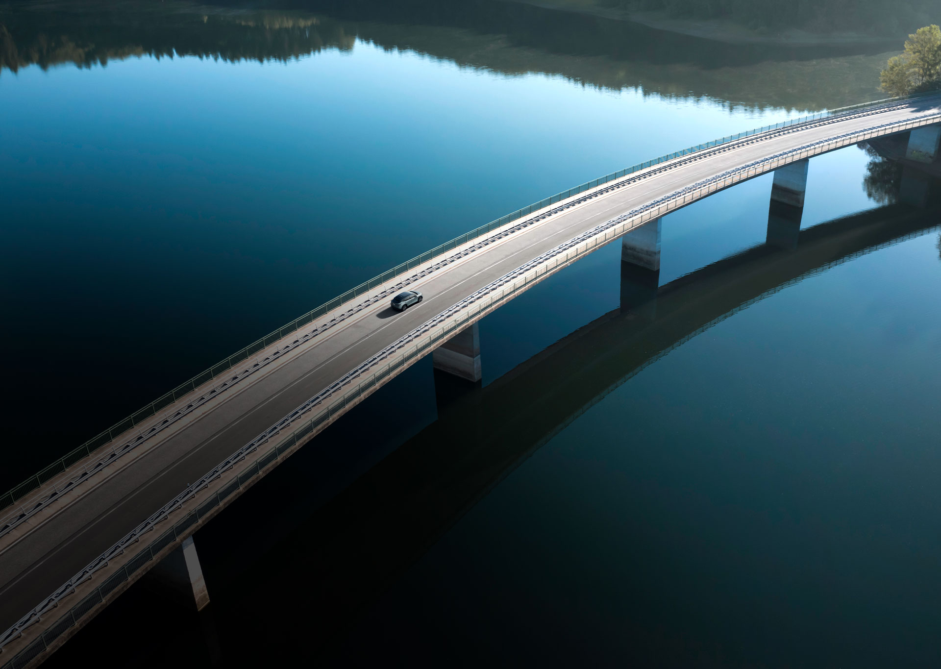 Nissan ARIYA overhead view cornering in a scenic environment