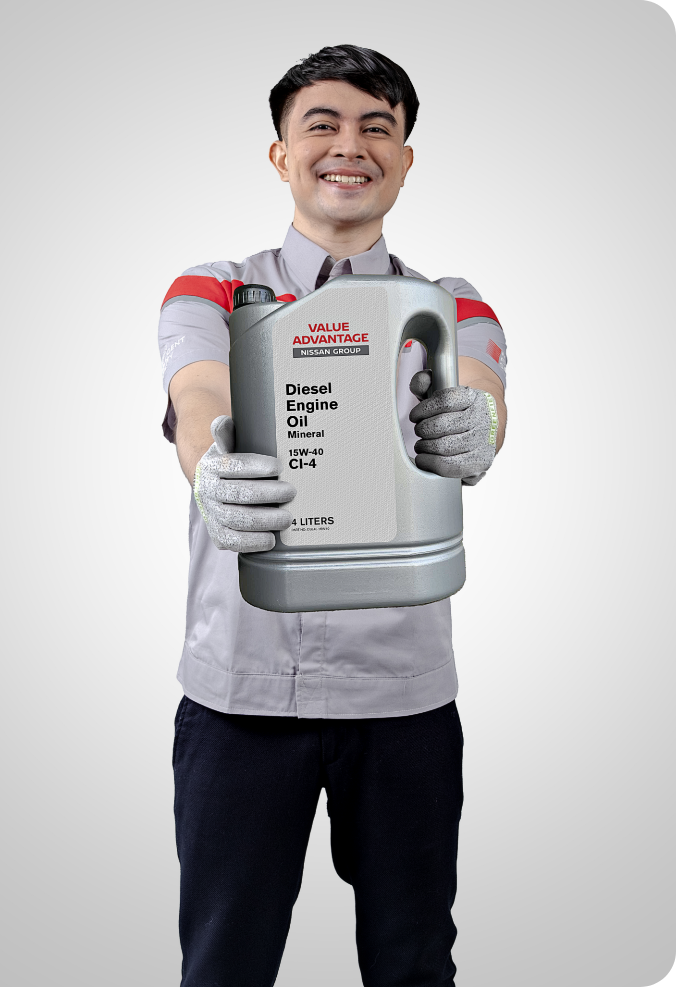 Nissan mechanic holding engine oil